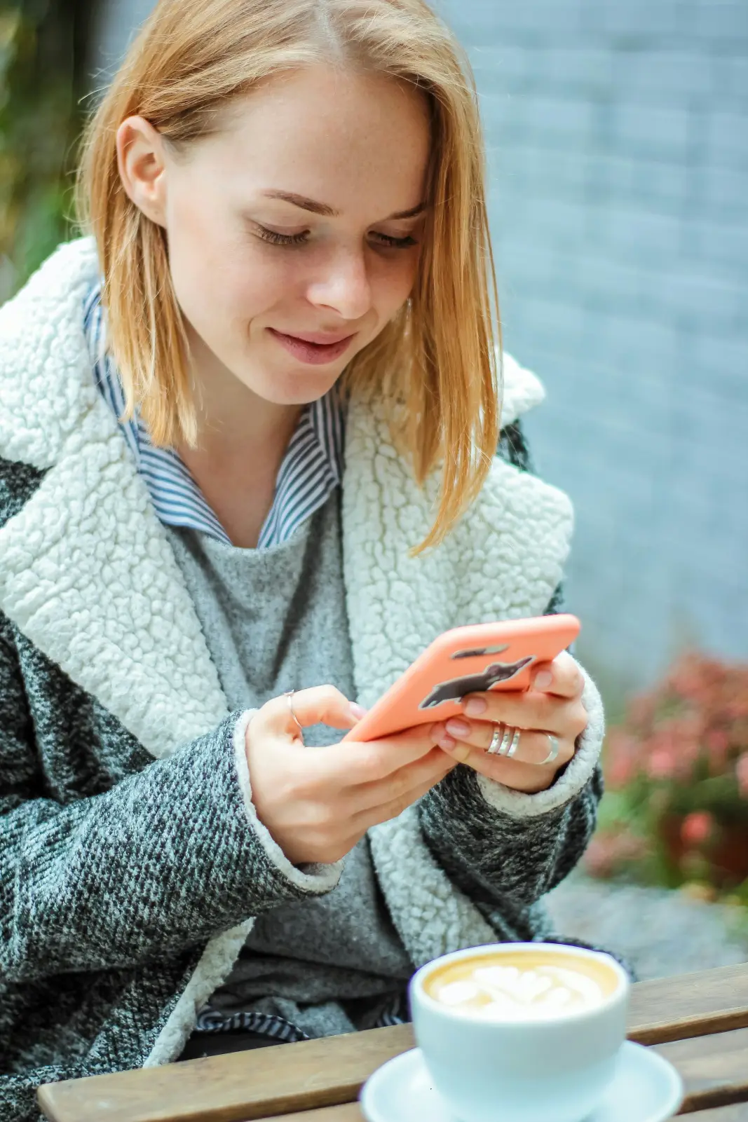 Hands holding a phone, typing a message